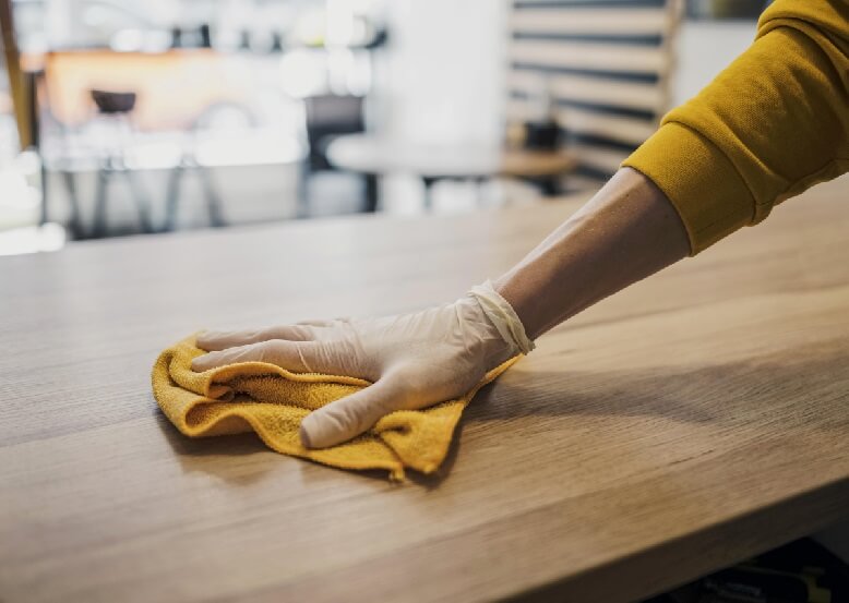 use spent coffee grounds for cleaning tables