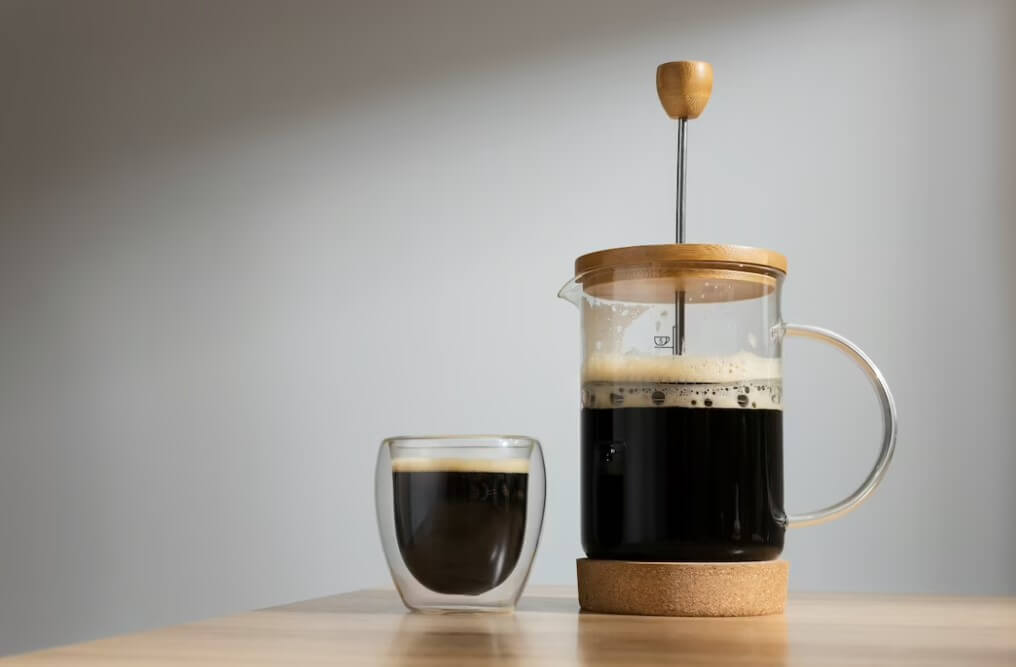 a french press drip coffee maker on a table
