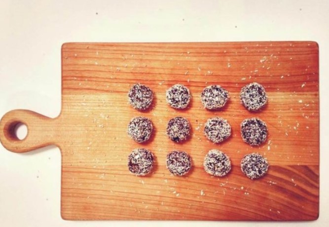 rum balls with coffee and plum on a wooden plate